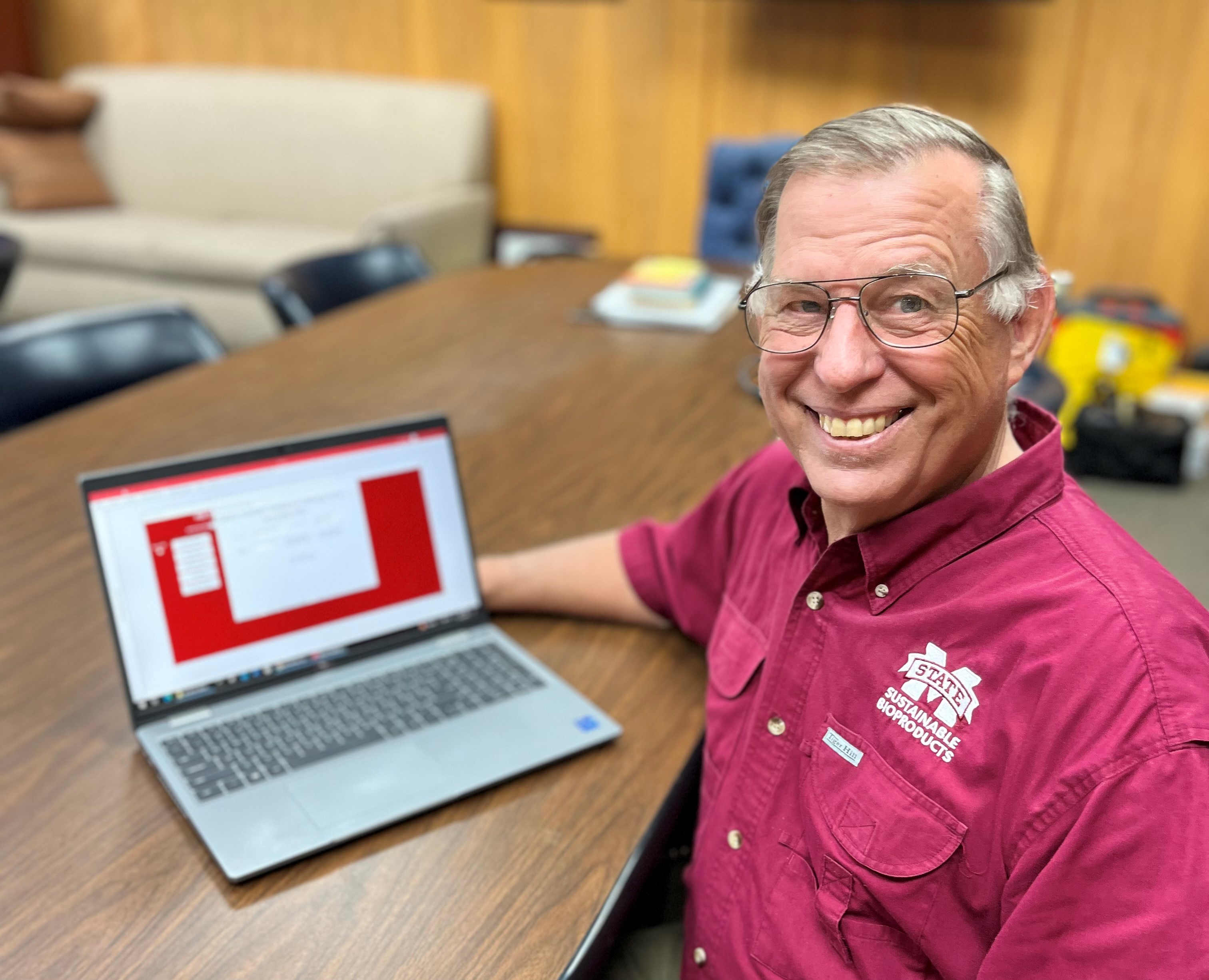 Faculty at table with computer