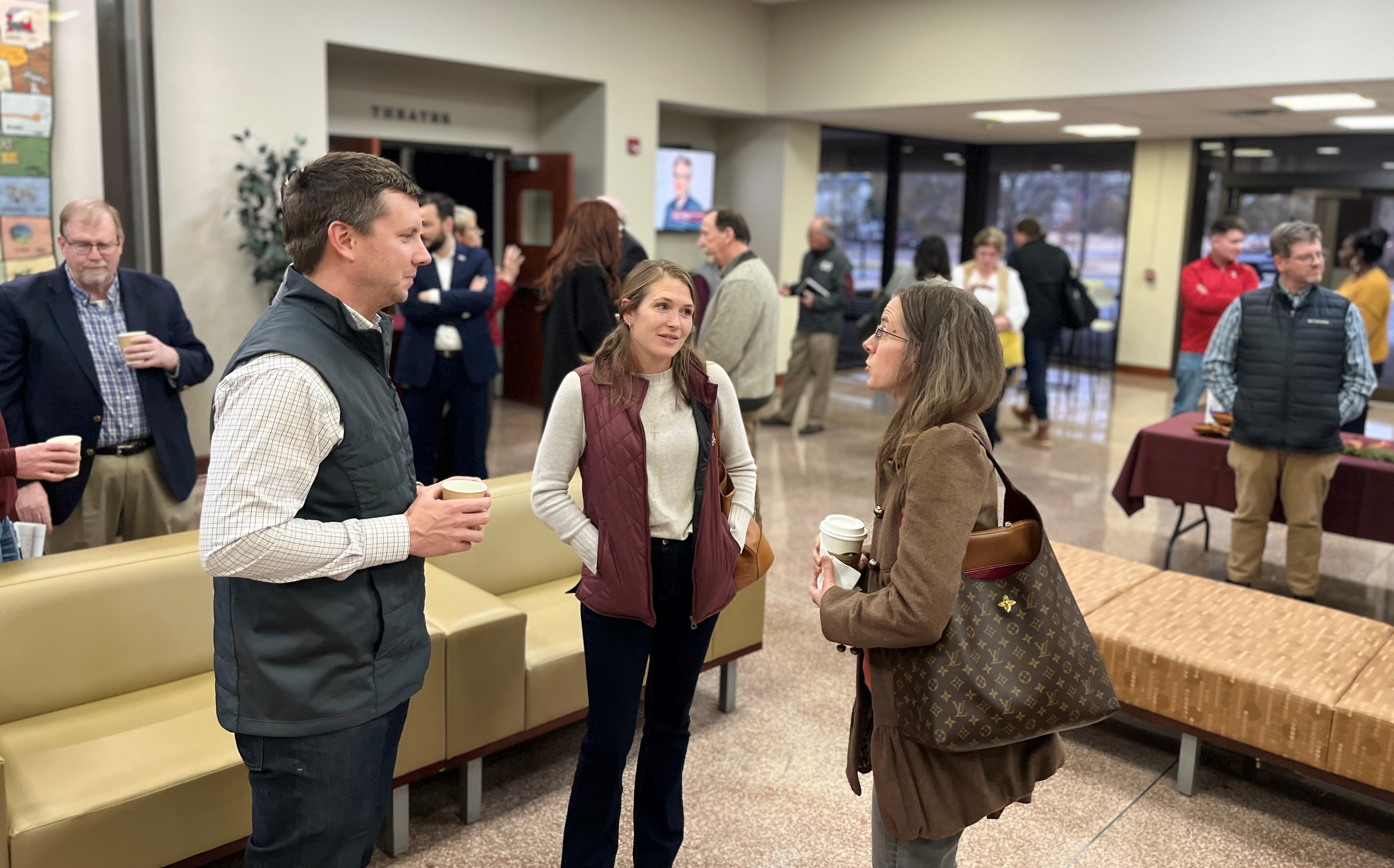 Faculty visit in the Bost Conference Center after hearing about mid-career faculty success project findings.